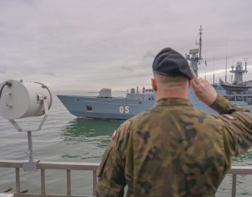 NATO kicks off huge BALTOPS drill to deter Russia Sailor in camouflage uniform saluting as a gray warship with the number 05 passes by on the water.