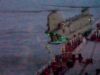 Video shows British forces board Russian shadow tanker Blurred night photo of a seafront pier with a concrete extension over water and green lights along its edge.