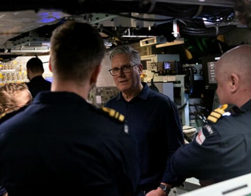Starmer tells NATO chief UK will publish DIP before summit An older man with glasses speaks to a group of uniformed sailors inside a technical control room or ship compartment.