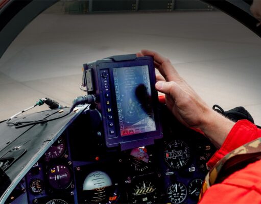Red Arrows get Inzpire GECO system for 2026 season Pilot in a red flight suit uses a rugged tablet-style display in the fighter jet cockpit, surrounded by instrument gauges.