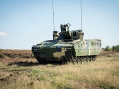Rheinmetall lands huge Romania deal for Lynx, Skyranger Armored military tank on a grassy field under a clear blue sky, facing left.