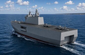 Large gray aircraft carrier&ndash;style ship sailing in the open sea with three helicopters on its flight deck under a partly cloudy sky.