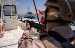 Briton guilty of brokering jets and missiles to war zones Soldier in camouflage aiming a rifle from the deck of a ship, with a small patrol boat visible in the water in the background.