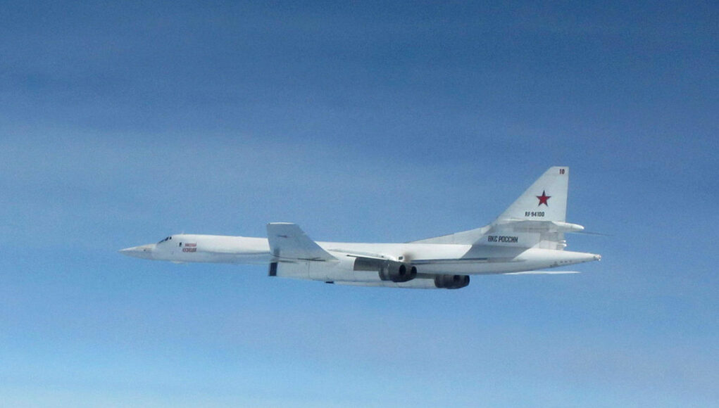 LOS-OFFICIAL-20180920-0524-0024.jpg.iCfh9N2BMovxSx9jYBMA.sbeGo6wfFF White military cargo aircraft with a red star on the tail flying over a clear blue sky, four engines visible under the wings.