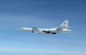 Russian military flights near UK rising, defence chief says White military cargo aircraft with a red star on the tail flying over a clear blue sky, four engines visible under the wings.