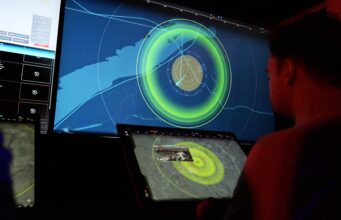 MARSS opens Nice base and doubles AI team for drone fight People in a dark control room monitor a large radar/map display with bright green concentric rings on a wall-sized screen