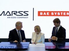 MARSS picked to run command brain of BAE drone-killer Three businesspeople in suits signing documents at a table, with MASS and BAE SYSTEMS logos in the bright backdrop.