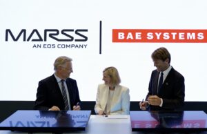MARSS picked to run command brain of BAE drone-killer Three businesspeople in suits signing documents at a table, with MASS and BAE SYSTEMS logos in the bright backdrop.