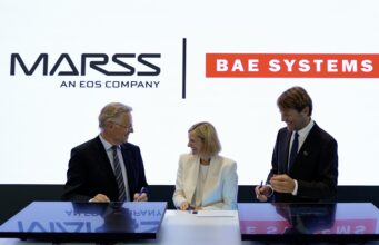 MARSS picked to run command brain of BAE drone-killer Three businesspeople in suits signing documents at a table, with MASS and BAE SYSTEMS logos in the bright backdrop.