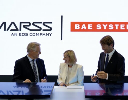 MARSS picked to run command brain of BAE drone-killer Three businesspeople in suits signing documents at a table, with MASS and BAE SYSTEMS logos in the bright backdrop.
