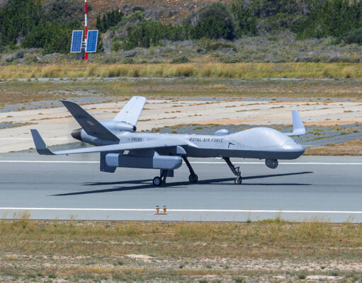 British drone spotted carrying covert spy pod Unmanned RAF surveillance aircraft on a runway, with two large wings and a light gray fuselage marked 'ROYAL AIR FORCE'.