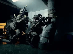 3 Commando Brigade renamed the UK Commando Force Special forces operators in full tactical gear crouch and aim rifles in a dim corridor of a vessel or building.