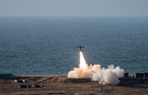 Britain shows off home-grown deep-strike weapon Small airplane launches a rocket from a coastal test site, flame and smoke plume rising toward the sky over the ocean.
