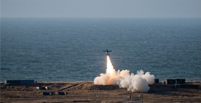 Britain shows off home-grown deep-strike weapon Small airplane launches a rocket from a coastal test site, flame and smoke plume rising toward the sky over the ocean.