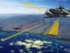 Leonardo Seaspray radar picked for Australian surveillance Military aircraft in flight over coastal mountains with colorful radar/flight data overlays projected on the cockpit view.