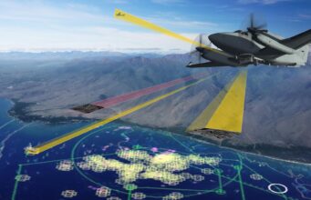 Leonardo Seaspray radar picked for Australian surveillance Military aircraft in flight over coastal mountains with colorful radar/flight data overlays projected on the cockpit view.