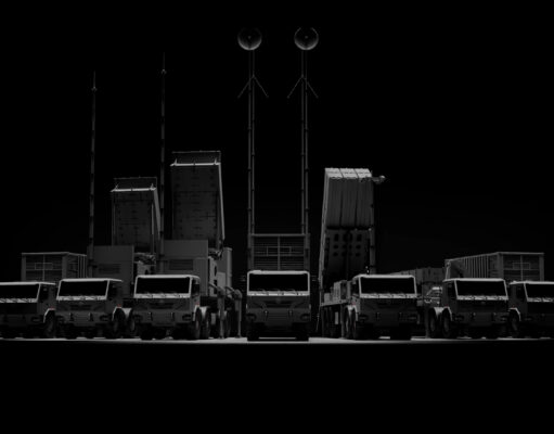 CSG unveils Trident layered air defence at Eurosatory Row of large trucks with tall antenna masts silhouetted against a dark background, forming a straight line.