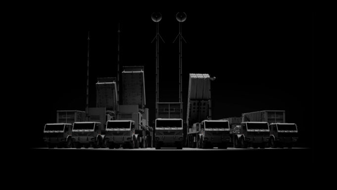 CSG unveils Trident layered air defence at Eurosatory Row of large trucks with tall antenna masts silhouetted against a dark background, forming a straight line.