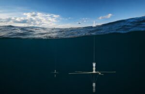 Ultra Maritime trials next-gen sub-hunting sonobuoy in UK Underwater research mooring: a vertical instrument with cross-shaped sensor hanging from a line beneath the surface of dark blue water.