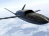 A sleek, black concept aircraft gliding above a cloudy sky with long, slender wings.