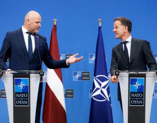 Rutte hails Latvia ahead of Ankara summit as drone downed Two suited men stand at podiums with NATO logos, speaking to each other during a press conference, with a Latvia flag and a NATO flag behind them.