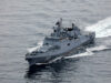 Russian warship fired warning shots at British vessel near UK Overhead view of a gray military destroyer cutting through the ocean with the hull number 799 visible on the bow; wake behind the ship.