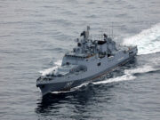 Russian warship fired warning shots at British vessel near UK Overhead view of a gray military destroyer cutting through the ocean with the hull number 799 visible on the bow; wake behind the ship.
