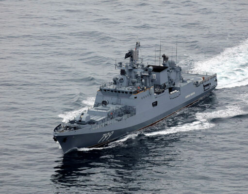 Russian warship fired warning shots at British vessel near UK Overhead view of a gray military destroyer cutting through the ocean with the hull number 799 visible on the bow; wake behind the ship.