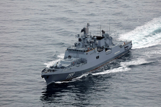 UK updates on Russian warning shots from drifting frigate Overhead view of a gray military destroyer cutting through the ocean with the hull number 799 visible on the bow; wake behind the ship.