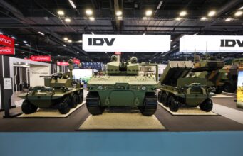 Leonardo’s IDV unveils uncrewed light tank at Eurosatory Military tanks on display at an exhibition hall with bright overhead lighting and large IDV signs in the background.