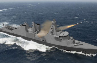 Grey naval warship at sea fires a missile from its launcher, with a helicopter on the aft deck and waves splashing nearby (hull number T31).