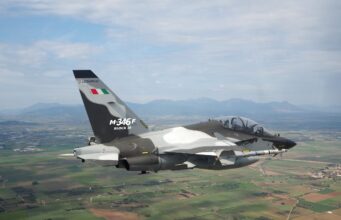 Indonesia signs for 12 M-346 F light fighters from Leonardo Military jet in flight, Italian M-346F trainer with flag on tail against a rural valley and mountains far below.