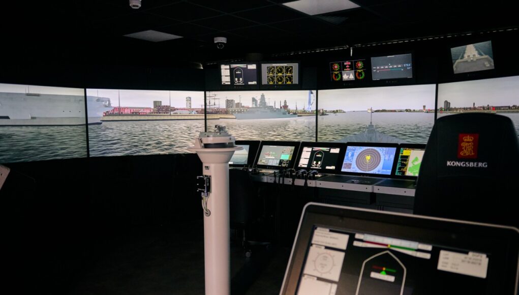 090726_CMS_172 Interior of a ship bridge simulator showing panoramic harbor screens and multiple navigation consoles.