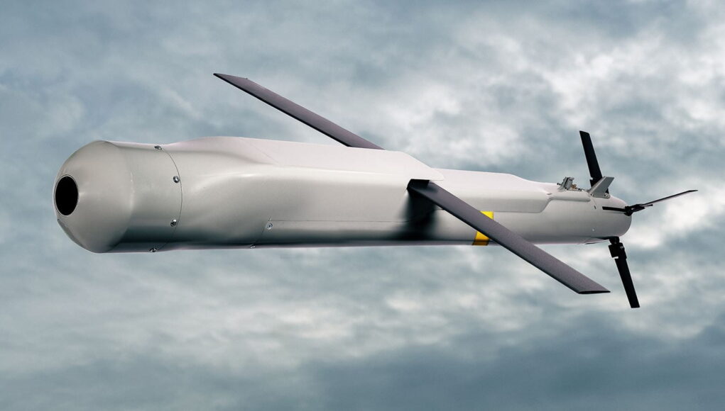 4558877 Red Kite-4_half 1920x1080 Unmanned aerial vehicle (drone) in flight against a cloudy sky with a gray fuselage and two large propellers.