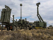 Sky Sabre doubling on track with deliveries from late 2026 Military mobile missile system on a truck with multiple vertical launch tubes, in a dry open area under a cloudy sky.