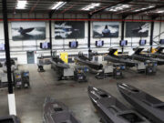 Kraken hits £1bn valuation after funding round Industrial boat factory with row of speedboats on workbenches and tools along the wall