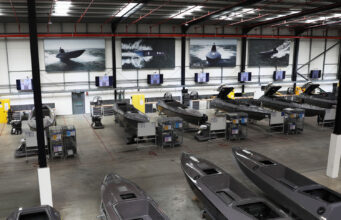 Kraken hits £1bn valuation after funding round Industrial boat factory with row of speedboats on workbenches and tools along the wall