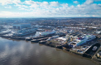 Balaena pitches yards for new UK-Dutch amphibious ships Aerial view of a harbor with large Stena Line ferries docked at a shipyard and warehouses nearby on the quay.