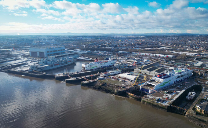 Balaena pitches yards for new UK-Dutch amphibious ships Aerial view of a harbor with large Stena Line ferries docked at a shipyard and warehouses nearby on the quay.