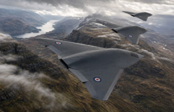 Storm Fighter drones to provide UK air and missile defence Three RAF flying-wing aircraft in formation above a winding fjord and rugged mountains in the distance.