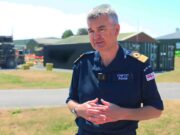From Thursday War to rewind button – how FOST is changing Man in a dark blue uniform stands outdoors, hands clasped, with a facility and equipment behind him.