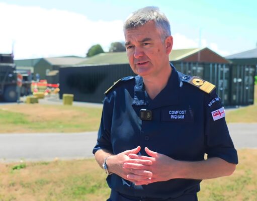 From Thursday War to rewind button – how FOST is changing Man in a dark blue uniform stands outdoors, hands clasped, with a facility and equipment behind him.