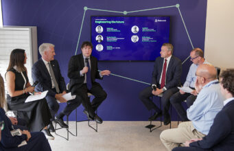 Babcock launches defence engineering skill study with Oxford Panel discussion with six professionals in a blue-walled conference room, microphones in hand, a large screen behind shows 'Engineering the future'.