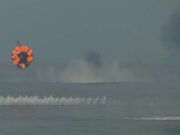 British warship unleashes hail of gunfire in the Arctic Circular fireball ring rising over the ocean from a distant explosion; smoke plumes in the sky above choppy water