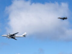 Russia chapping on the door of NATO, Labour MP warns Two military aircraft in formation: a white four-engine propeller bomber on the left and a dark jet on the right against a blue sky with clouds.