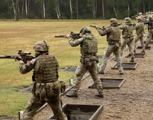 Royal Navy shooters take top UK marksmanship prize with KS1 Soldiers in camouflage gear firing rifles at an outdoor firing range, lined up in a row with tactical vests and helmets.