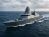Warship cruising at sea, gray stealthy hull slicing through waves under cloudy sky
