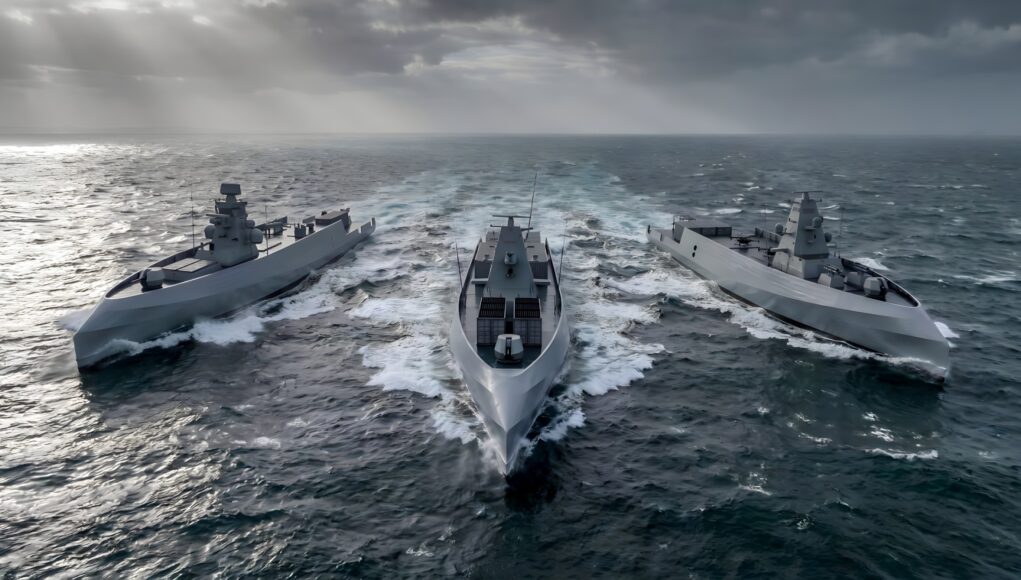 LUSV.remini-enhanced Three modern gray warships sail in rough seas, creating white wake under a stormy, sun-slashed sky.