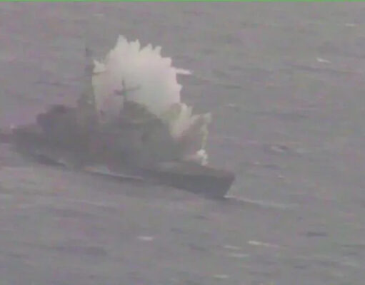 Canadian submarine sinks American warship in Pacific Ex Small boat on rough water with a large white spray behind it, suggesting a splash or plume from the vessel.