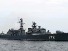 Russian warship opens fire near English coast Gray military destroyer with hull number 712 sailing on calm sea, multiple antennas and weapons on deck